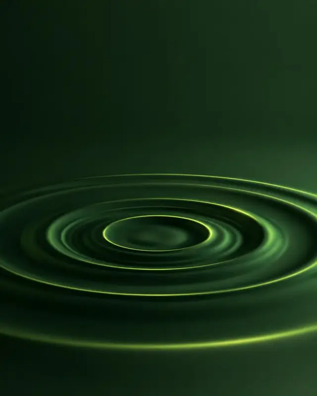 Quiet ripples spreading across a dark green surface