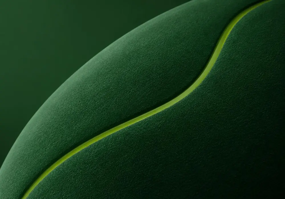 Close-up of a matte green surface with one bright groove